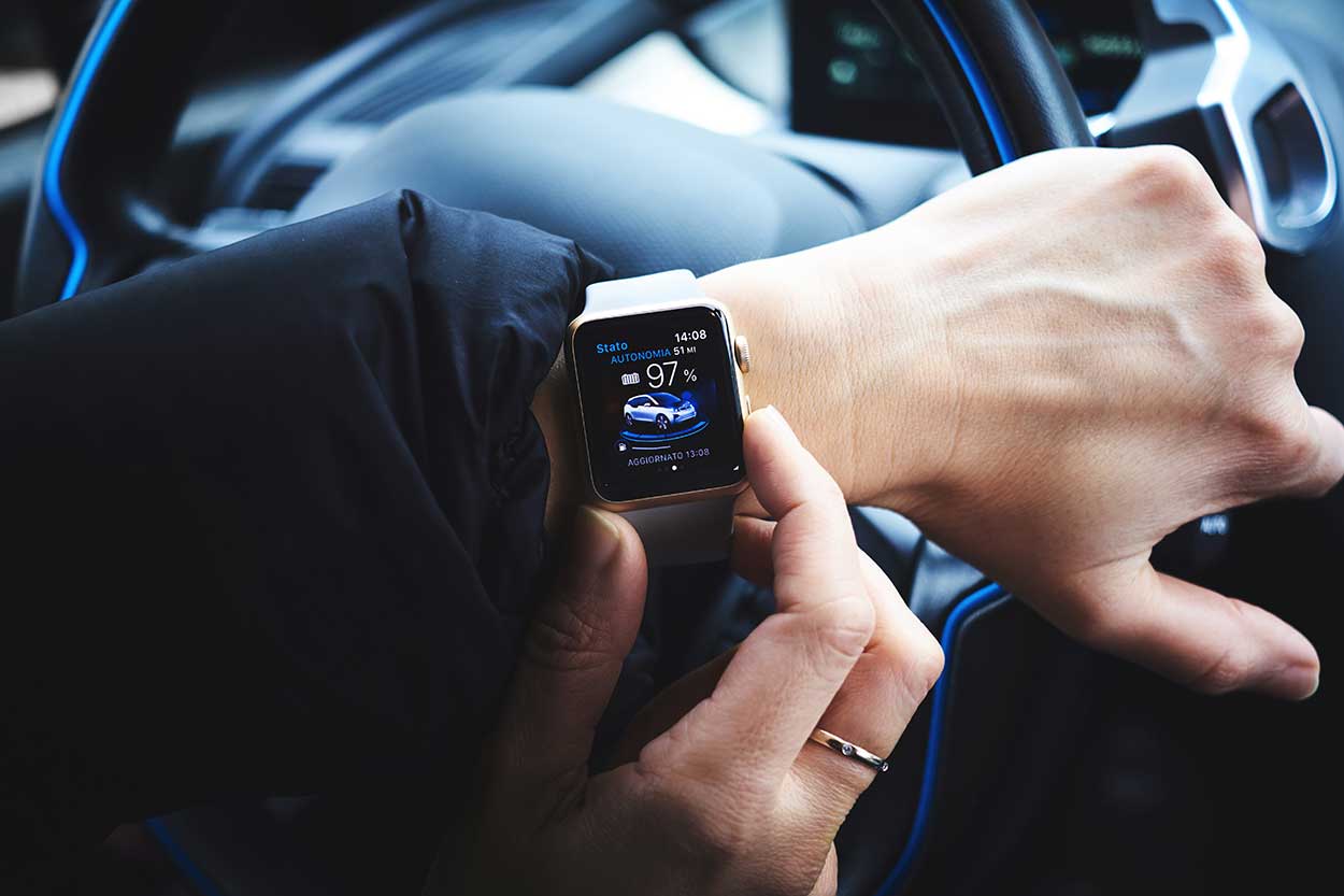 Driver checks car driving apps on iphone watch