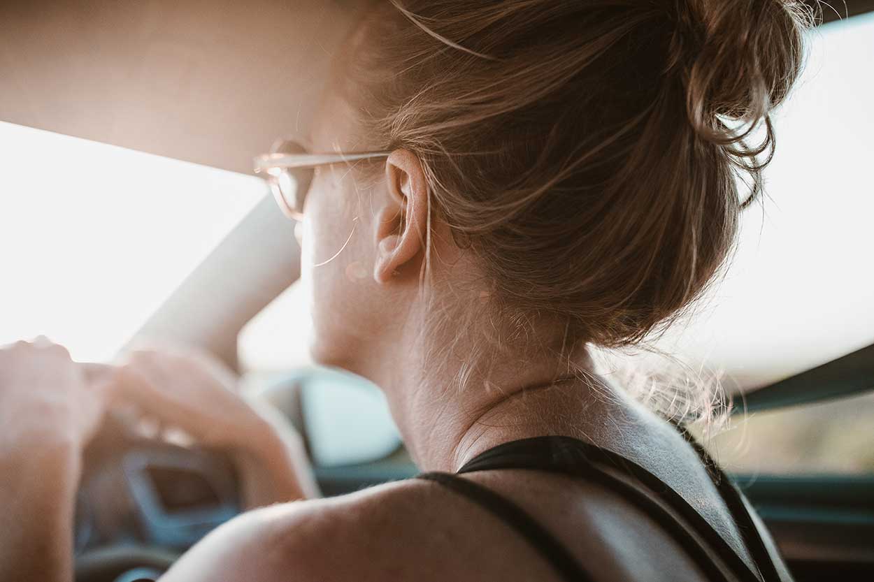 Woman wearing sunglasses thinking about financing next car