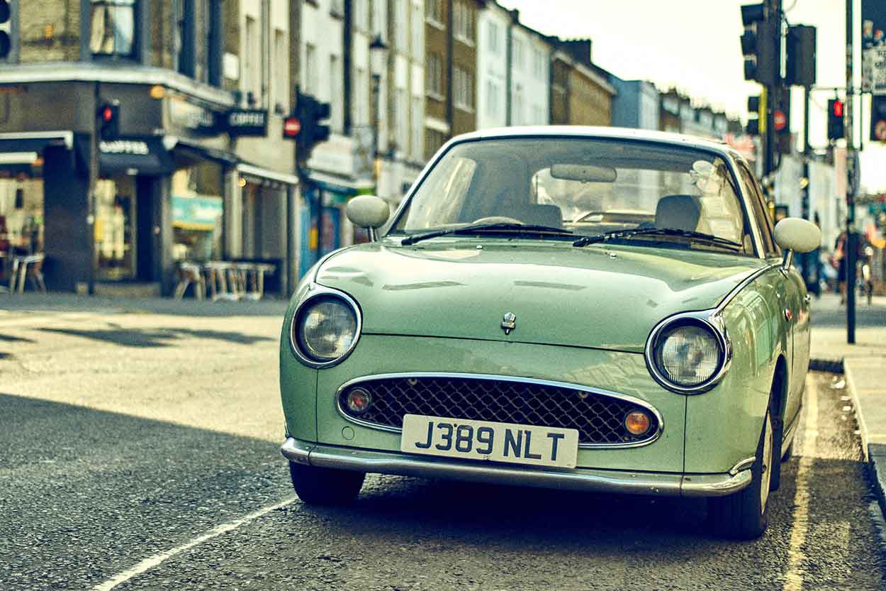 Retro style green car with old fashioned number plate