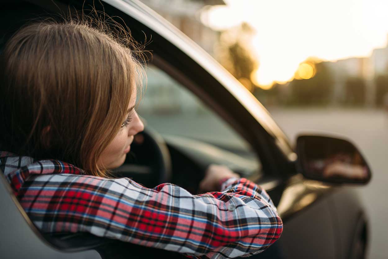 Woman driving whilst thinking about buying a new car