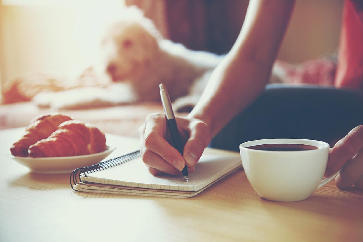 Woman signing her car finance paperwork