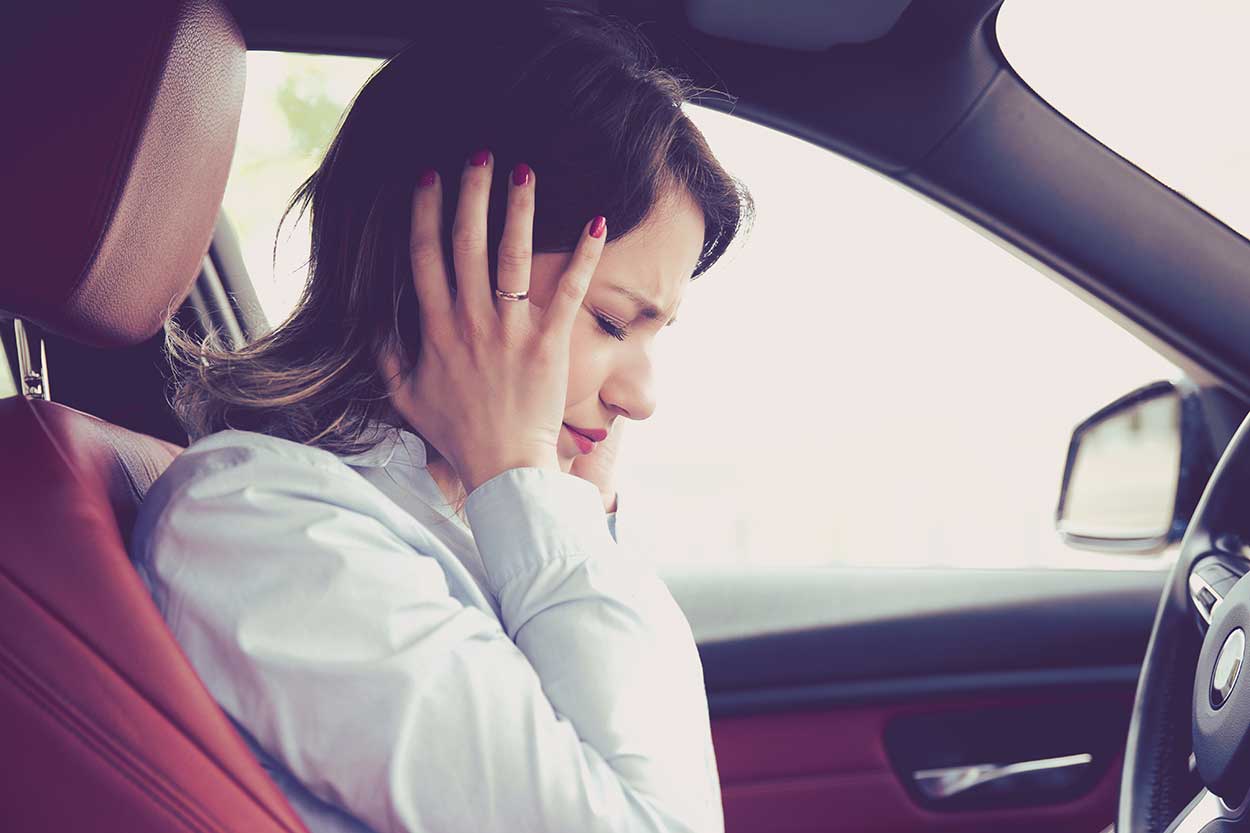 lady holding head in frustration at road rage incident