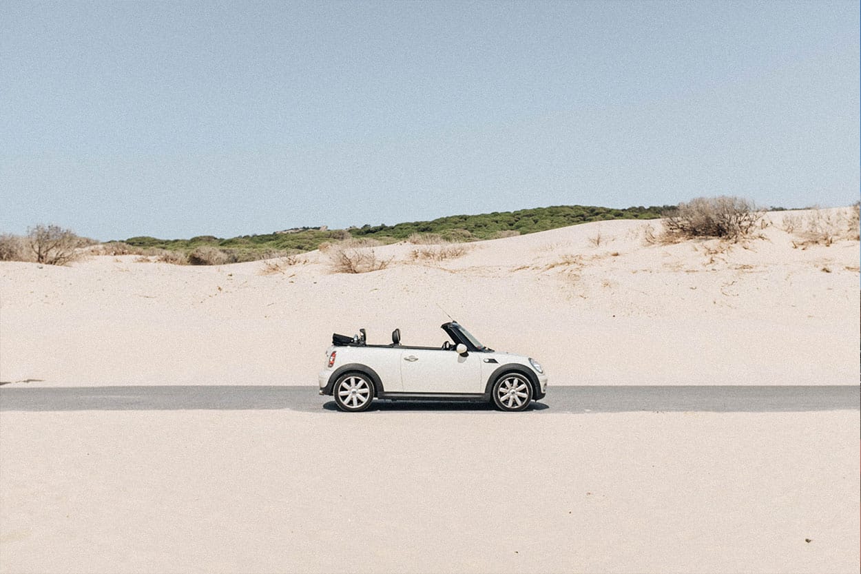 White mini convertible purchased with car loan parked on road