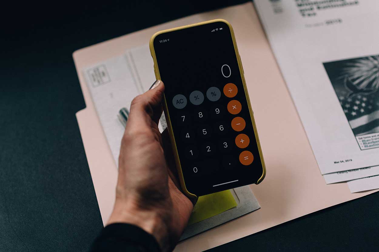 calculator being used to work out how to pay car finance