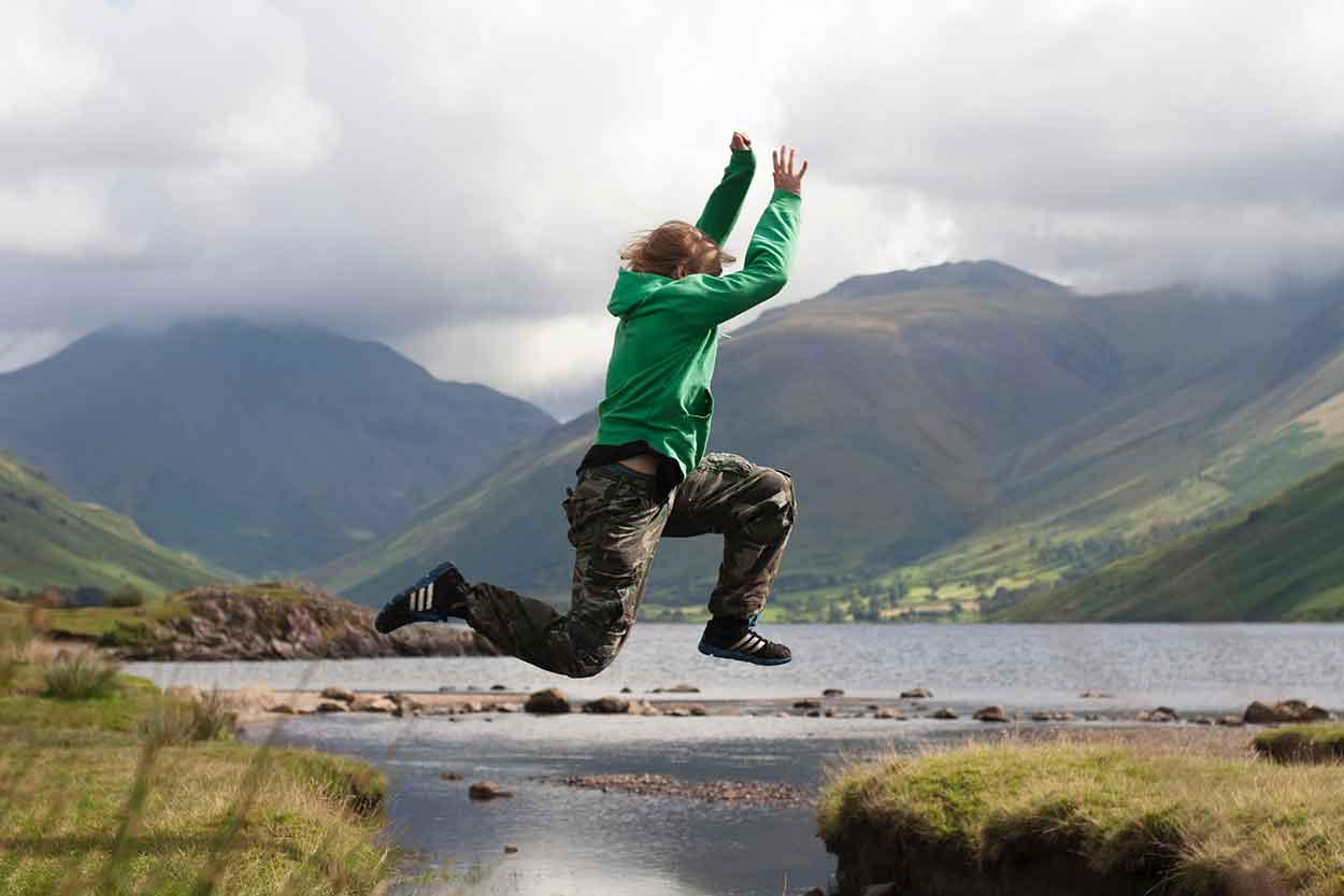 boy jumping river whilst on a staycation in uk