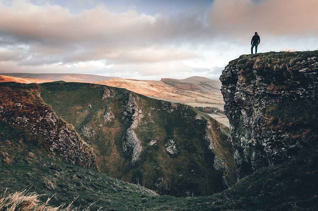 man standing over winnats pass on peak district staycation