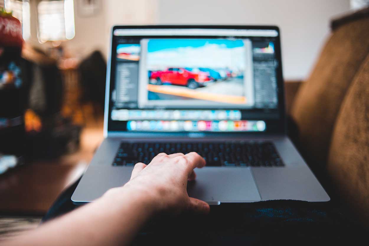 person using laptop to make online finance applications with car finance companies