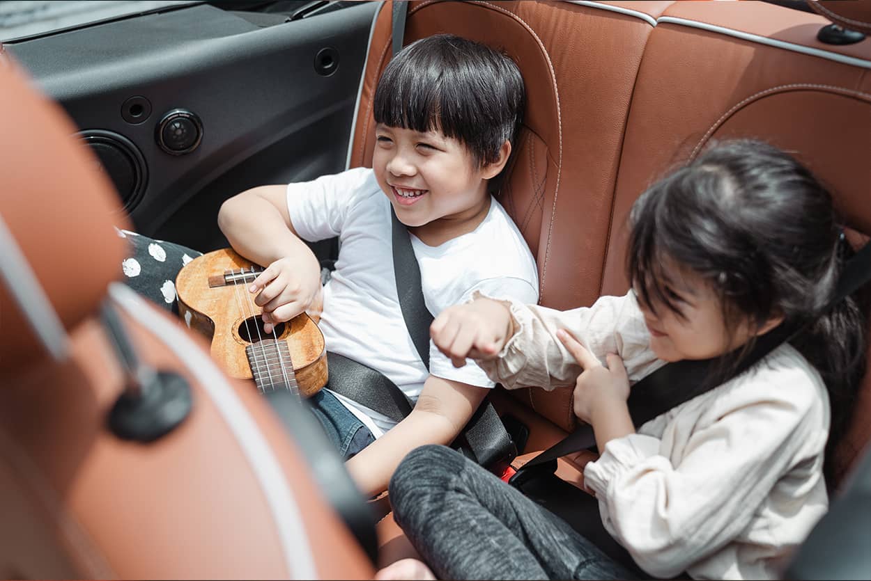 Children sat in the back of child-friendly cars going to school