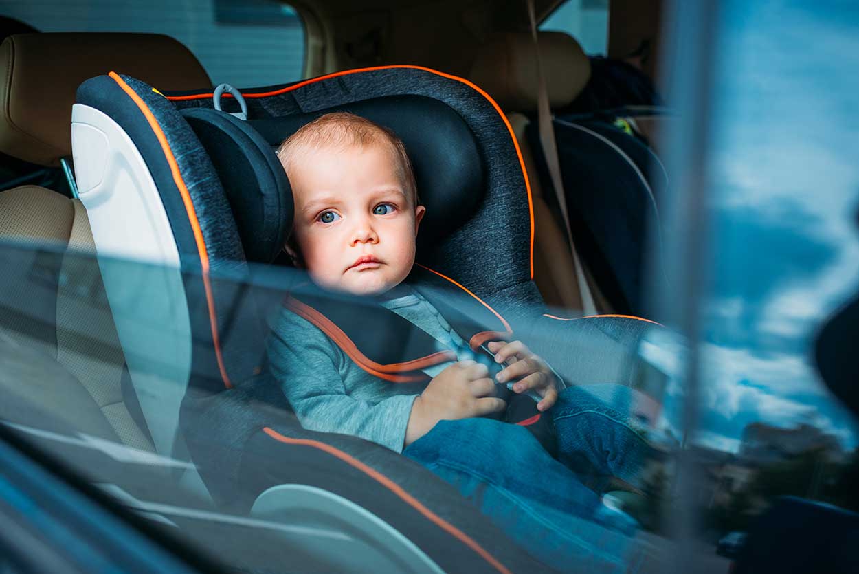 baby sitting in baby seat in best car for new parents