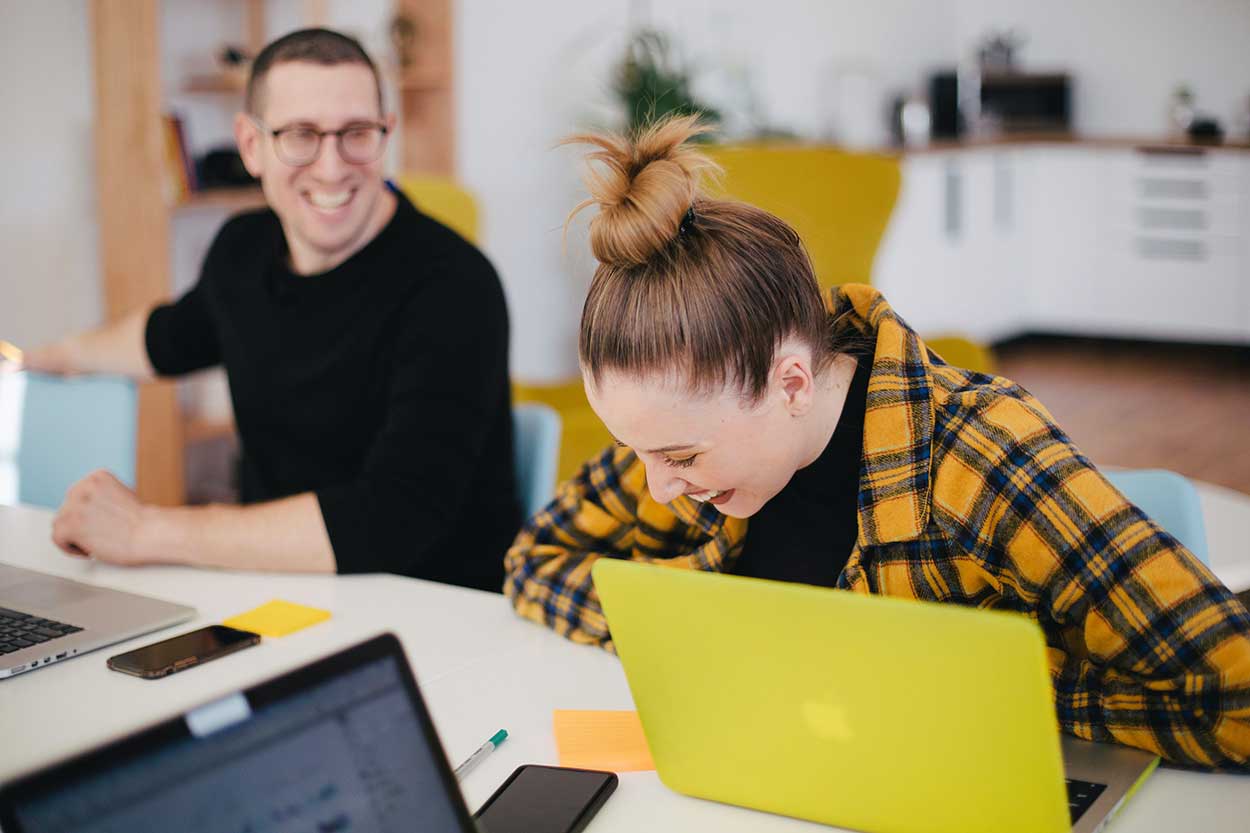 young man and lady laughing while trying to find car finance for students