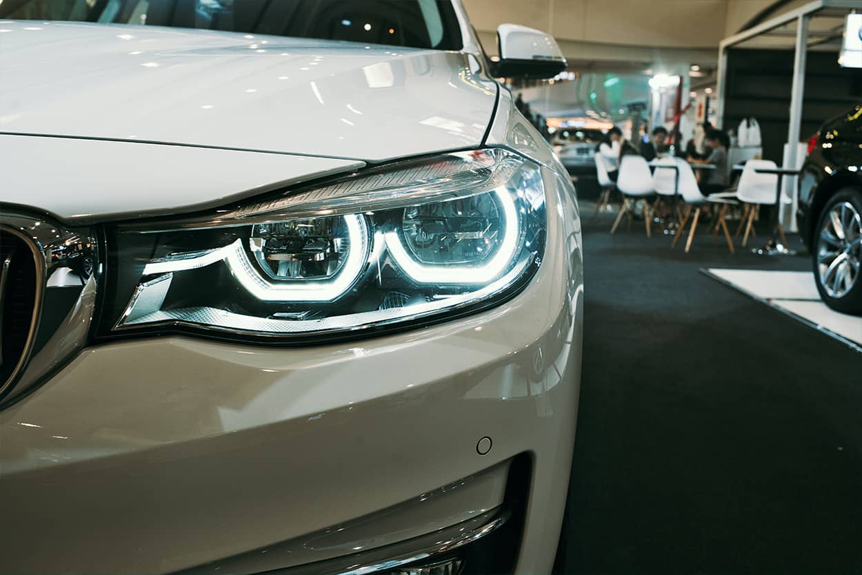 A white car in a dealership of popular cars