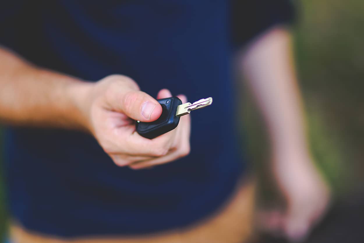 Man holding keys after buying first car on finance