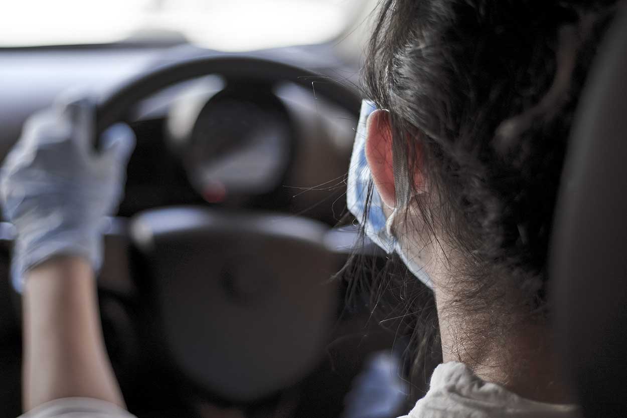 young woman taking driving lessons during covid