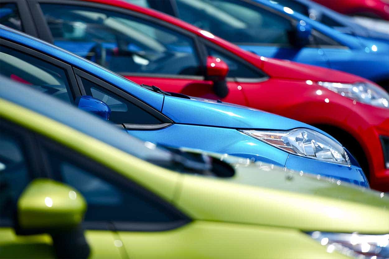 Colourful cars lined up ready for poor credit buyers