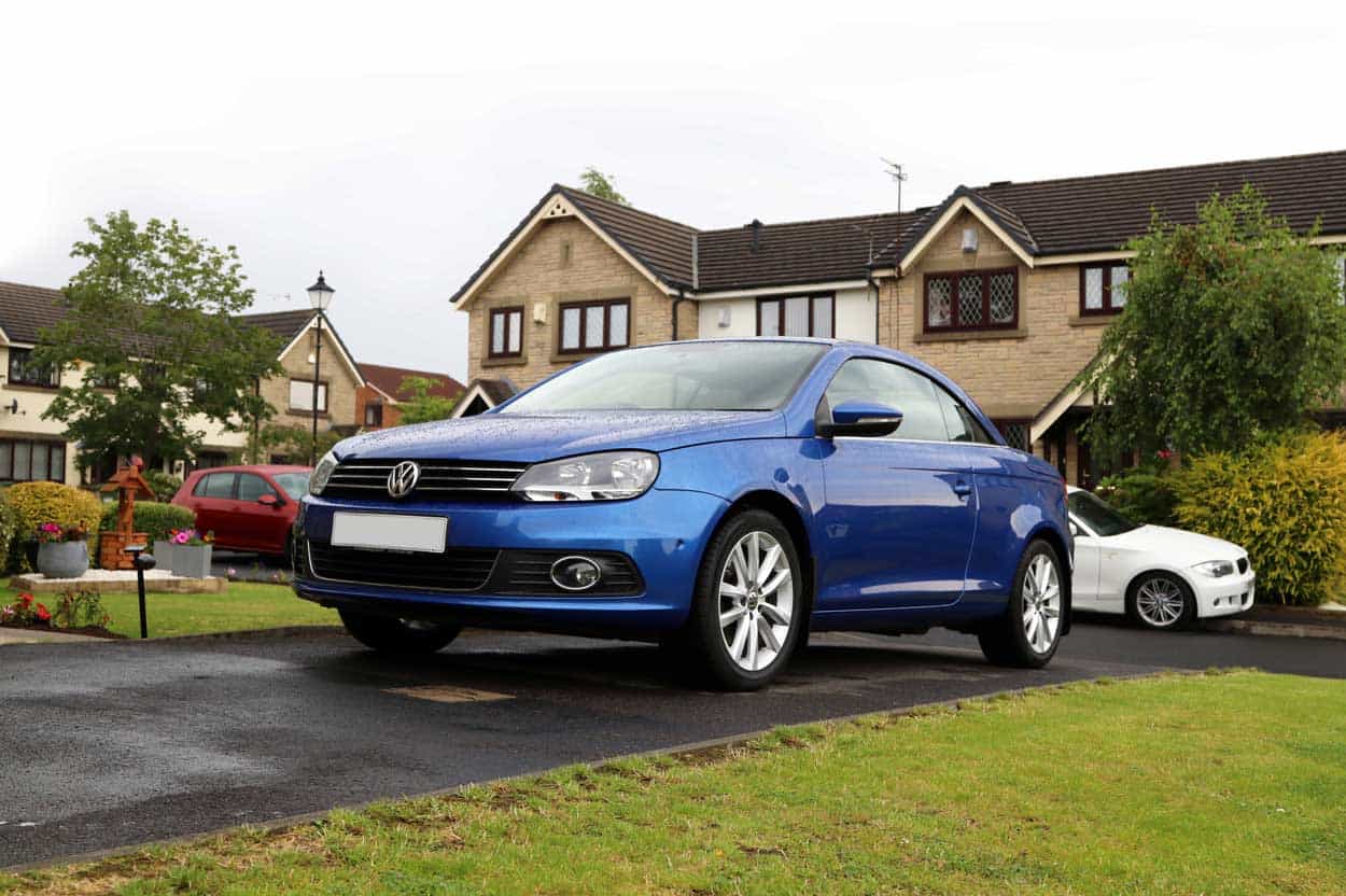 Blue car on customers drive delivered by Cinch