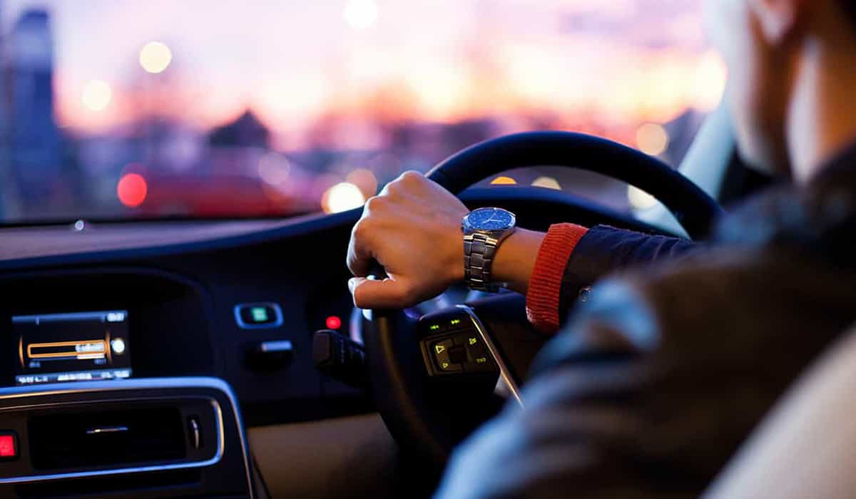 Person driving a car at dusk