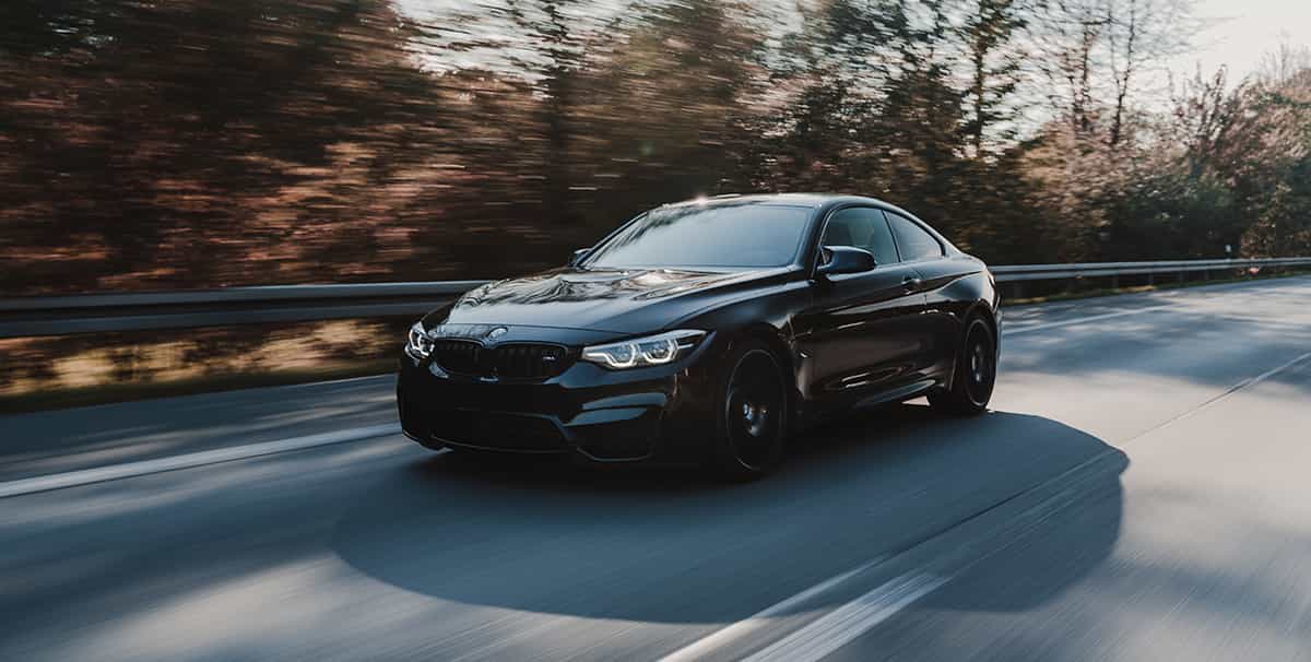 Black BMW driving on Motorway