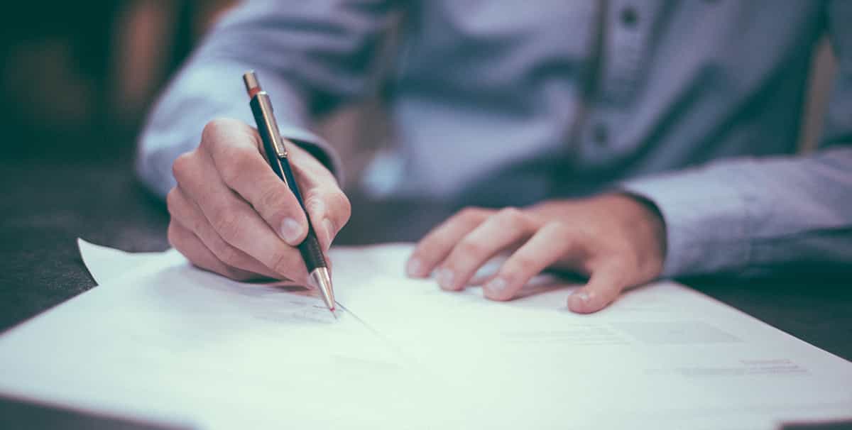 Man signing a car finance deal