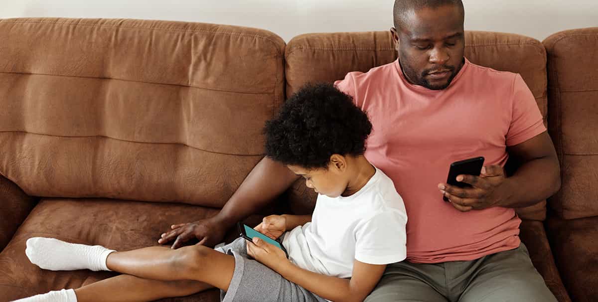 Dad checking how much car finance he qualifies for on his phone