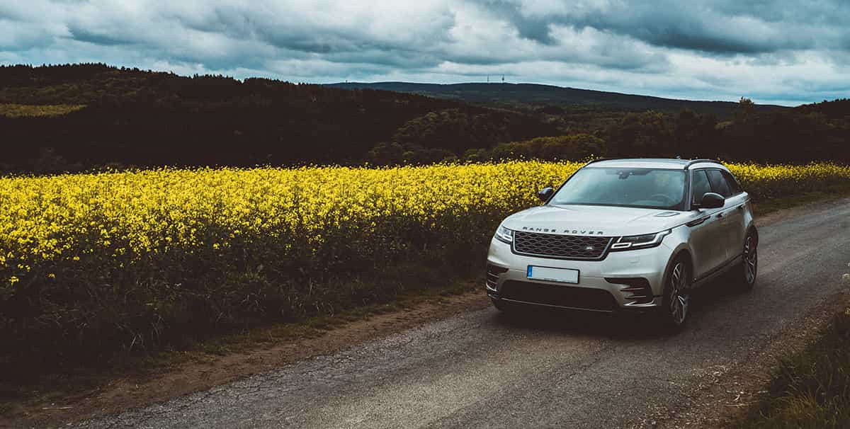 One of the best luxury SUVs driving through a field