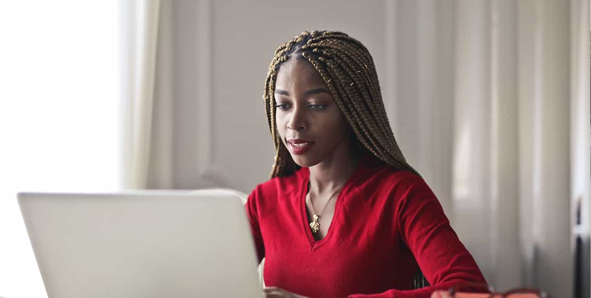 Woman using laptop to compare car finance