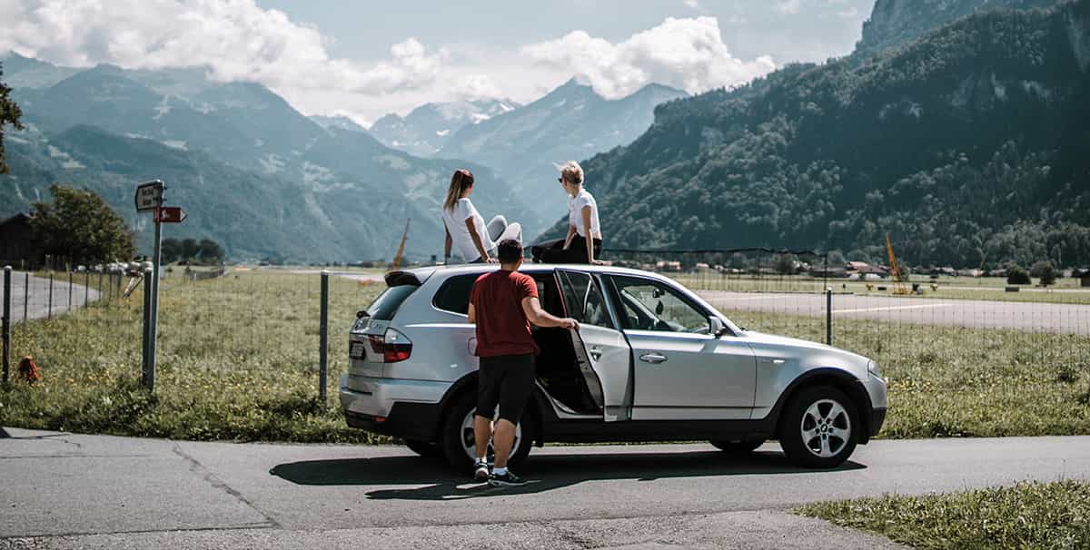 Friends on a road trip using premium petrol for better mileage