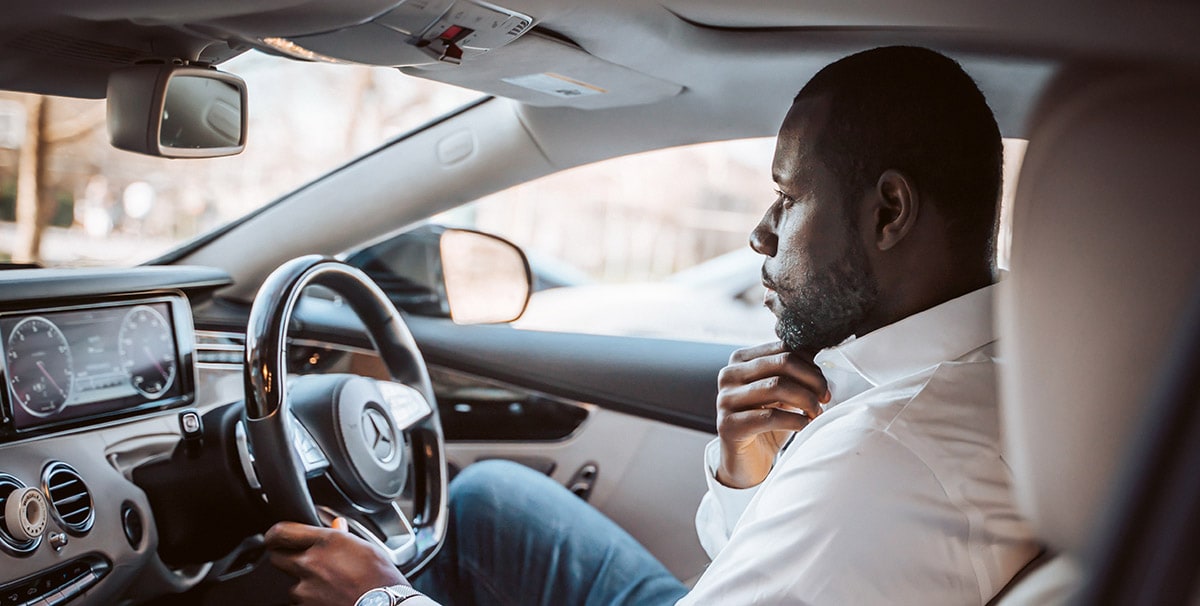 Man driving his car wondering how to save petrol