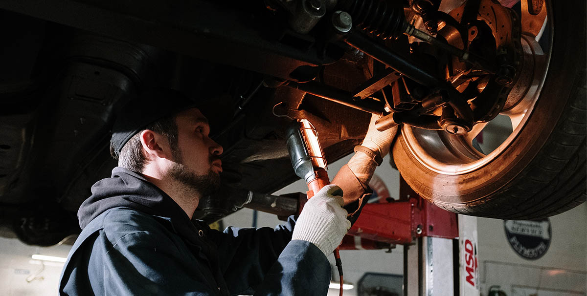 Man modifying a car that is on HP