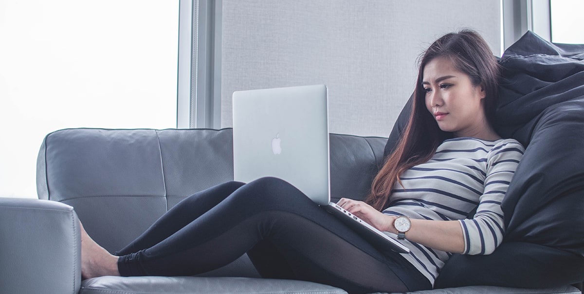 Woman browsing car finance companies on her laptop