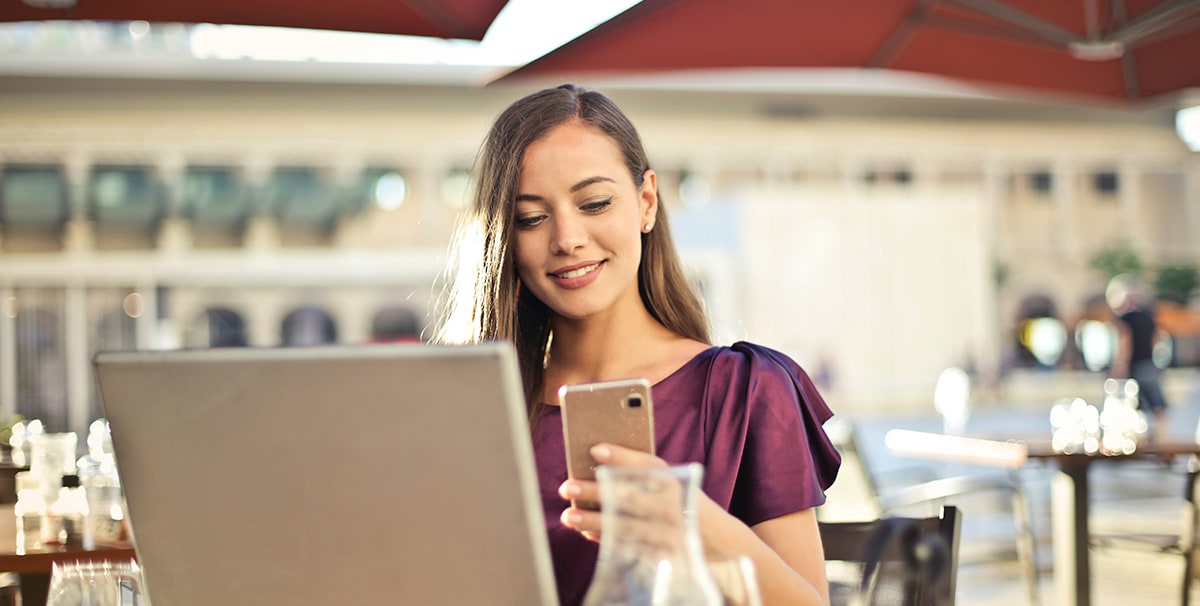 Woman looking on phone for best used car finance deals