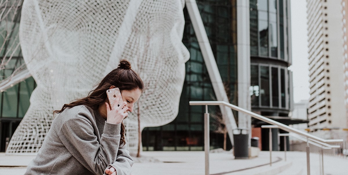 Woman on phone finding out if she can swap her car on finance