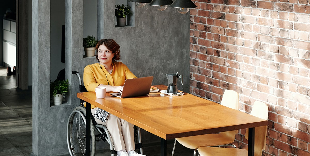 woman researching on laptop monthly car subscription in UK