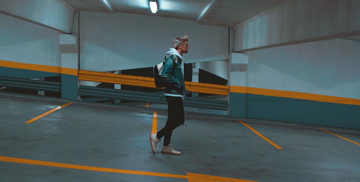 Man walking after parking his car in a secure parking lot