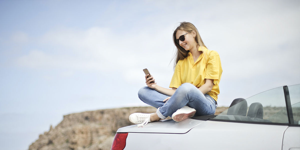 Woman sat on car