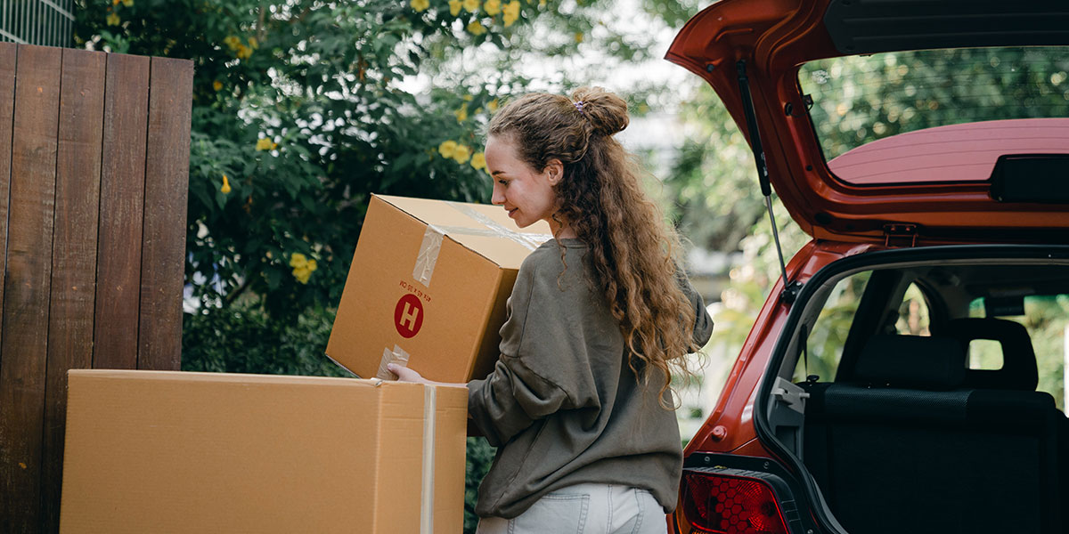 Woman unloading car and moving into new house