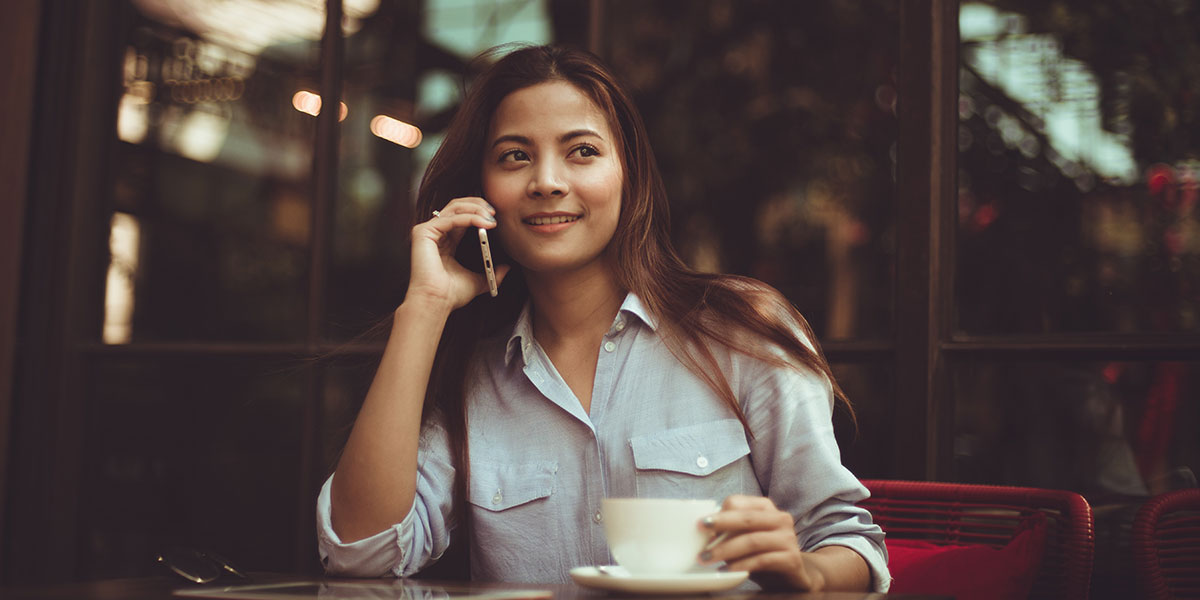 Woman at cafe using her phone