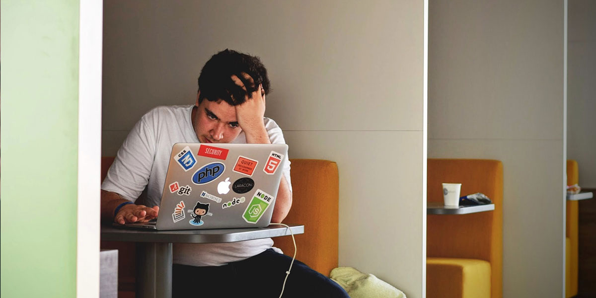 Frustrated person using laptop