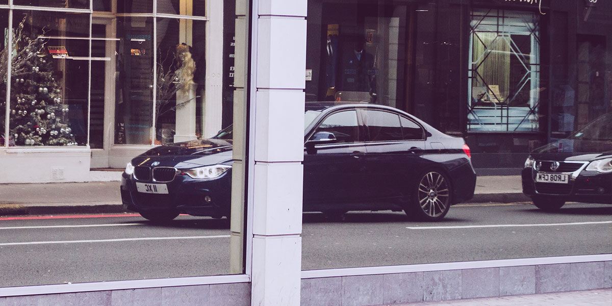 Car reflected in window