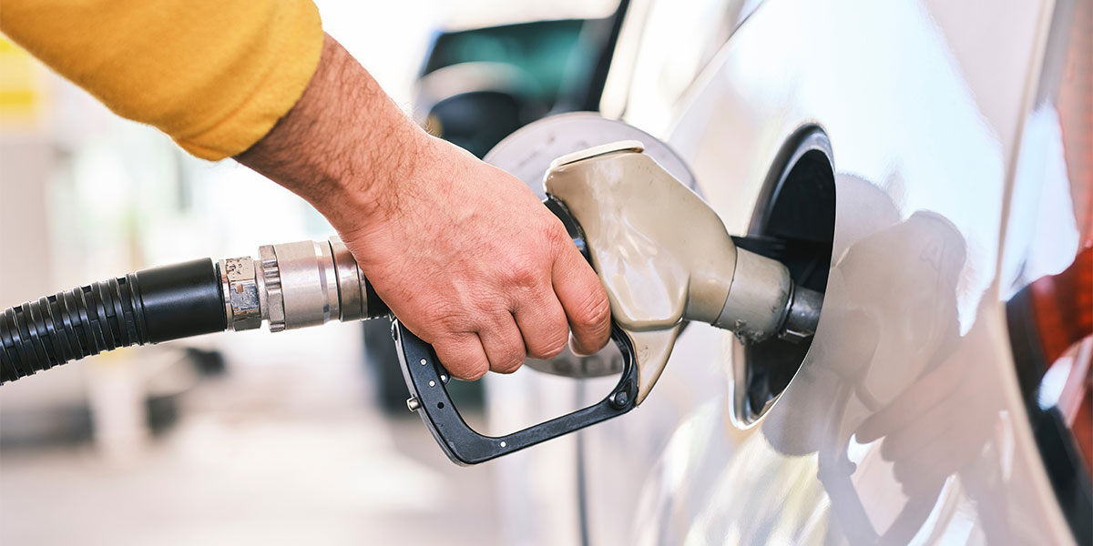 Man filing up his car with petrol to save on fuel