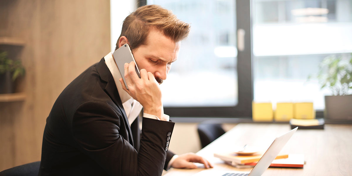 Man on phone trying to save money on car insurance