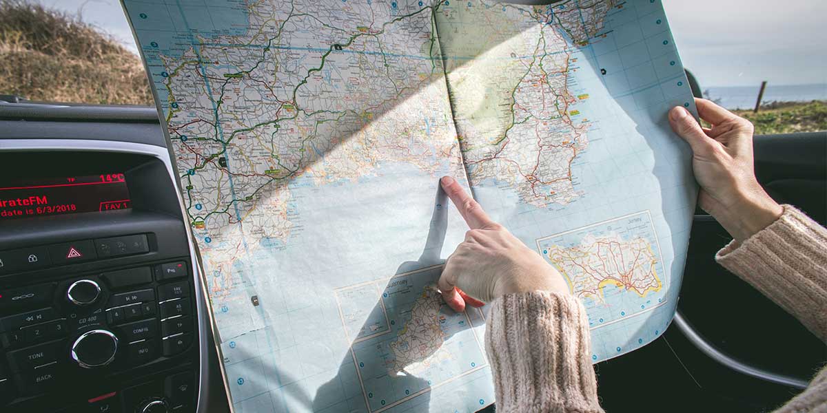 Person on a road trip looking at a road map