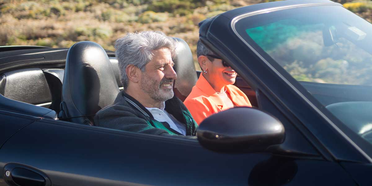 Older man driving a convertible