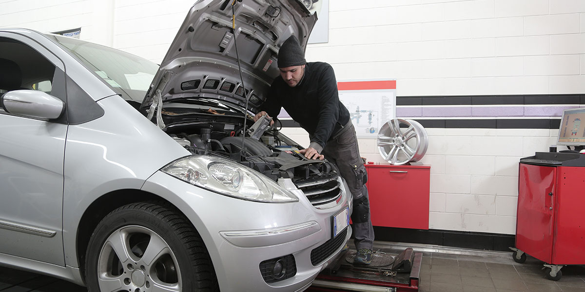 Car battery being replaced by mechanic