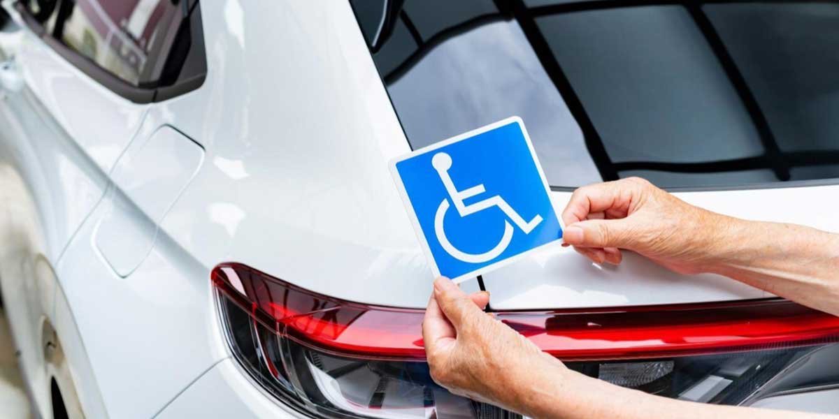 Disabled parking sticker stuck on the back of a car