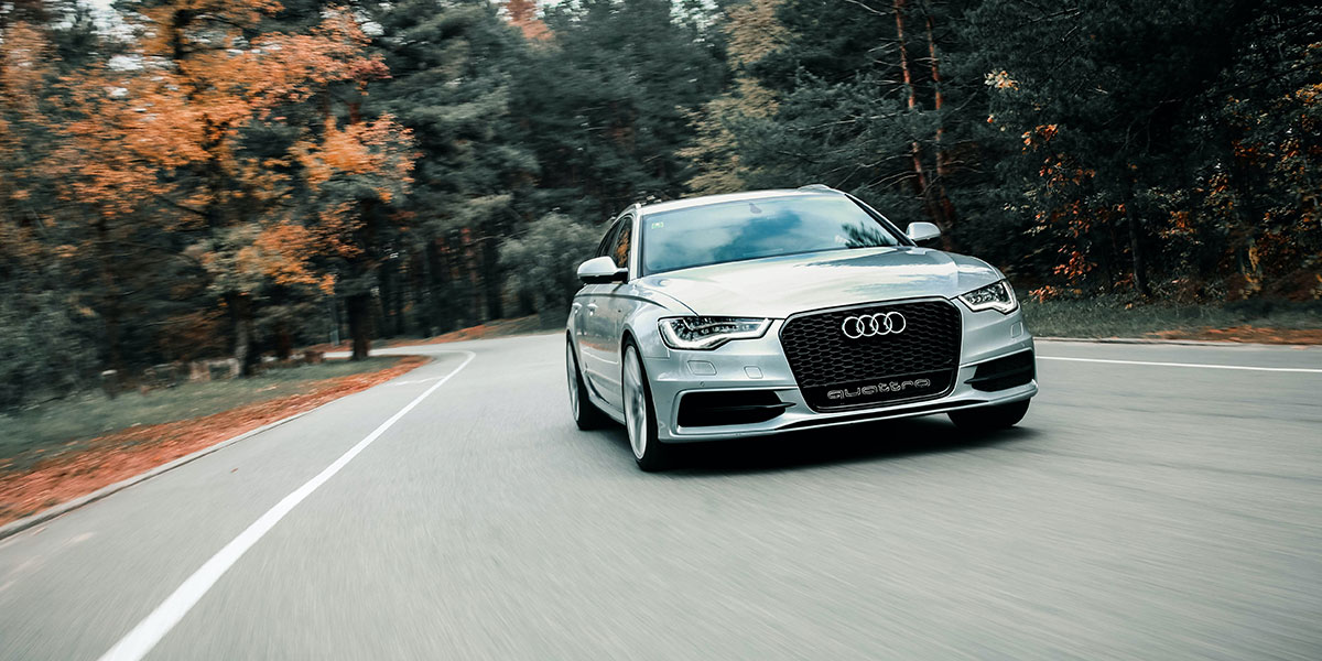 New Audi driving through forest