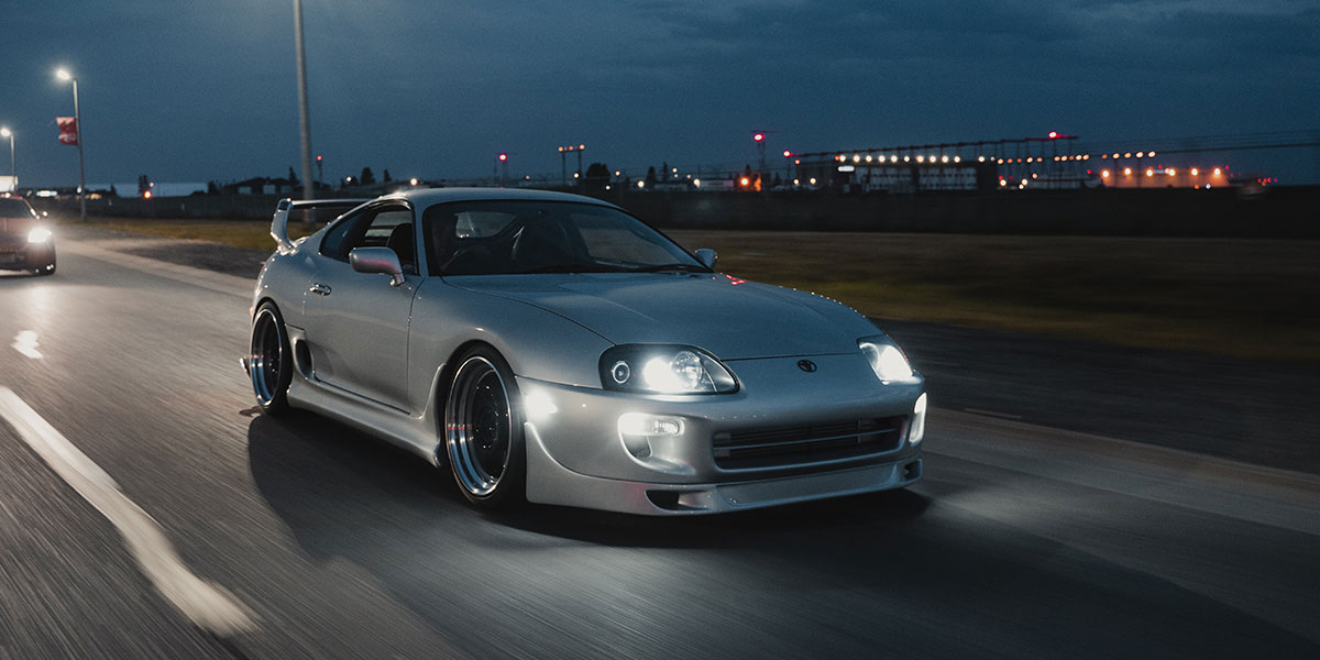White Toyota driving at night