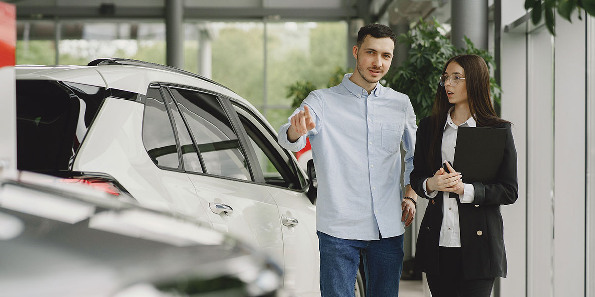 Man looking at buying a new car in a dealership