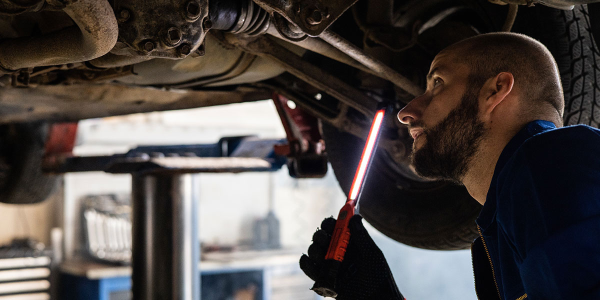 Mechanic inspecting under a car