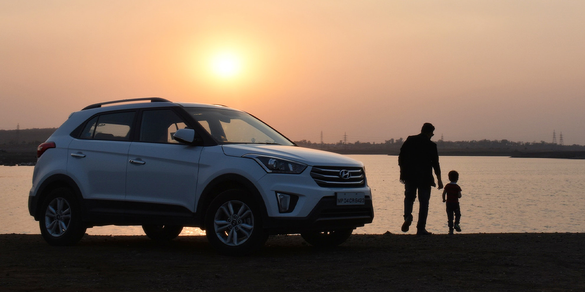 Car and family at sunset