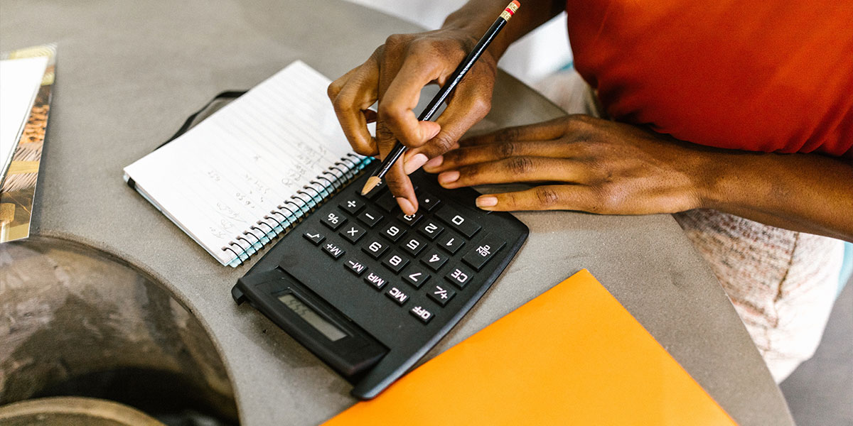 Woman using a calculator to budget